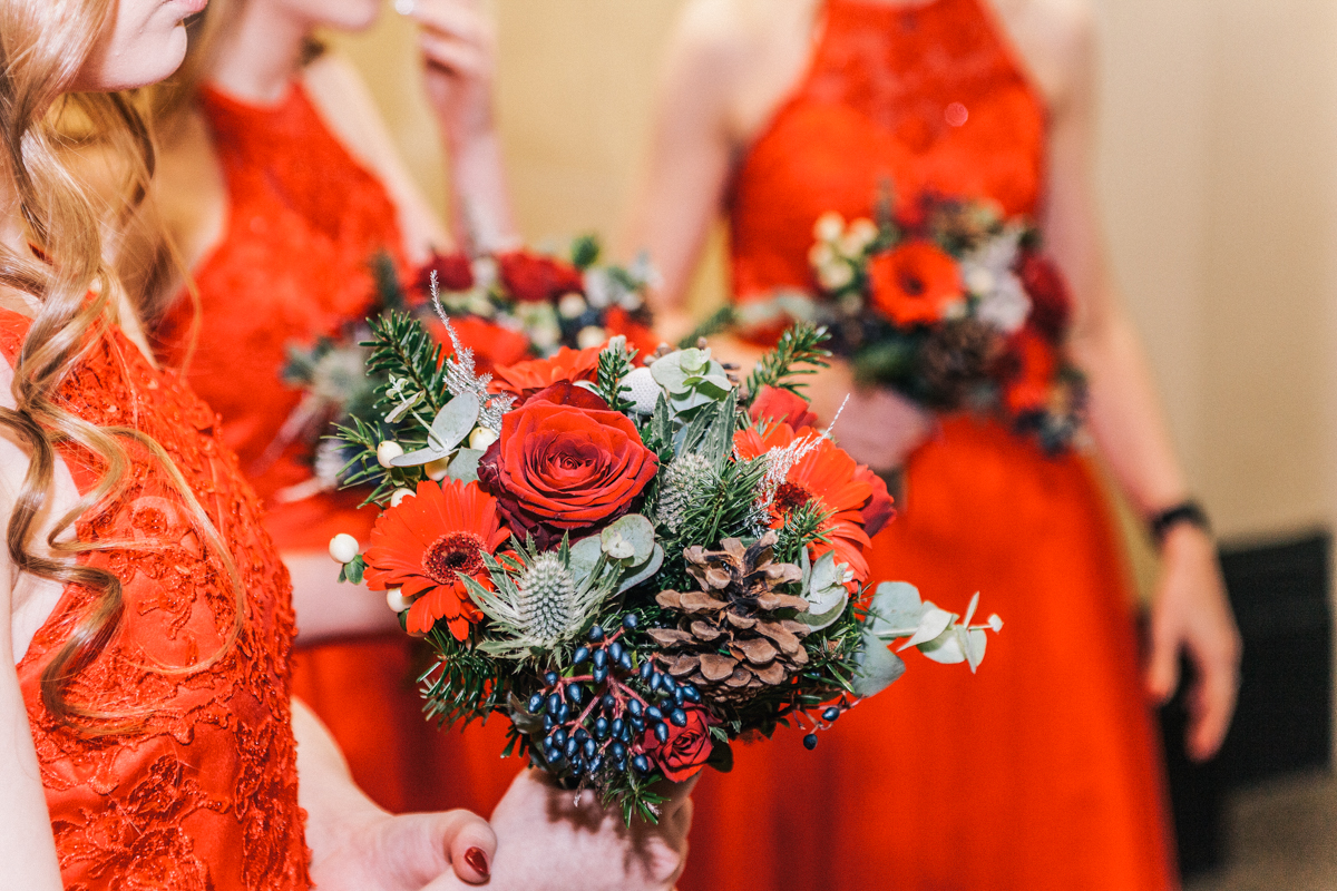 deep red winter christmas wedding bouquet bridesmaid holding