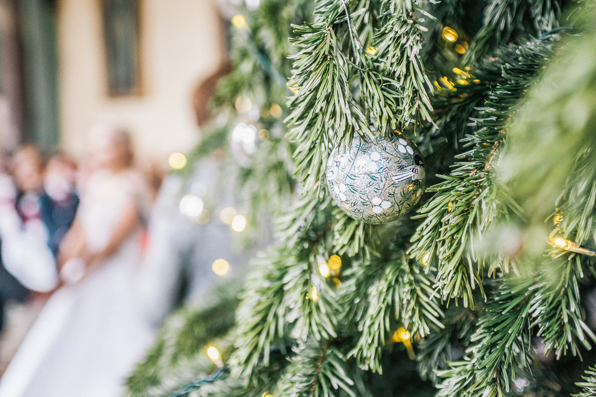 winter christmas wedding bauble ornament on christmas tree during bride groom ceremony