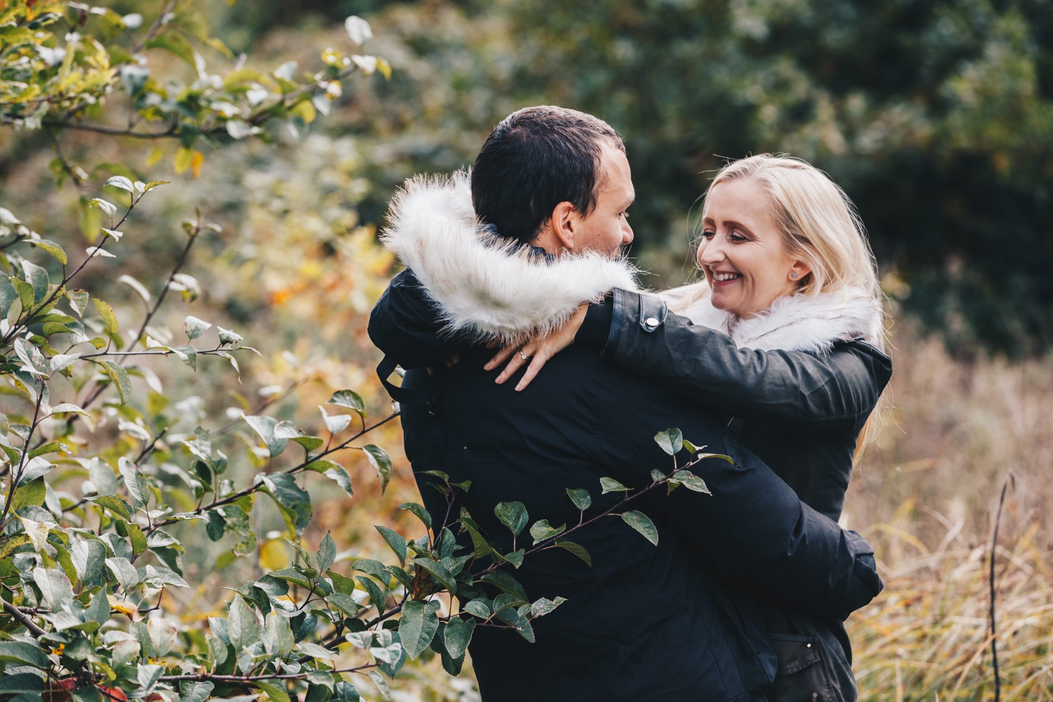 Engaged couple standing close in chorlton park manchester during a relaxed engagement shoot