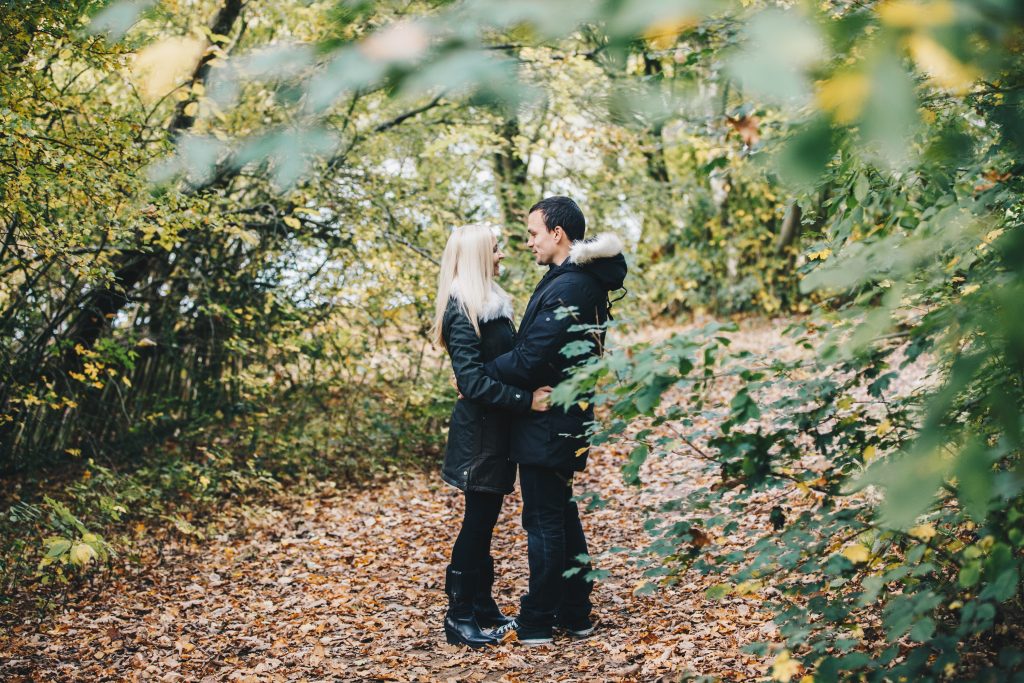 Couple sharing a quiet moment during sunset – candid autumn engagement pre wedding photography