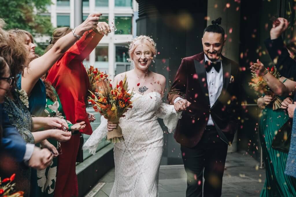 Bride holding bouquet with seasonal flowers and deep autumn tones