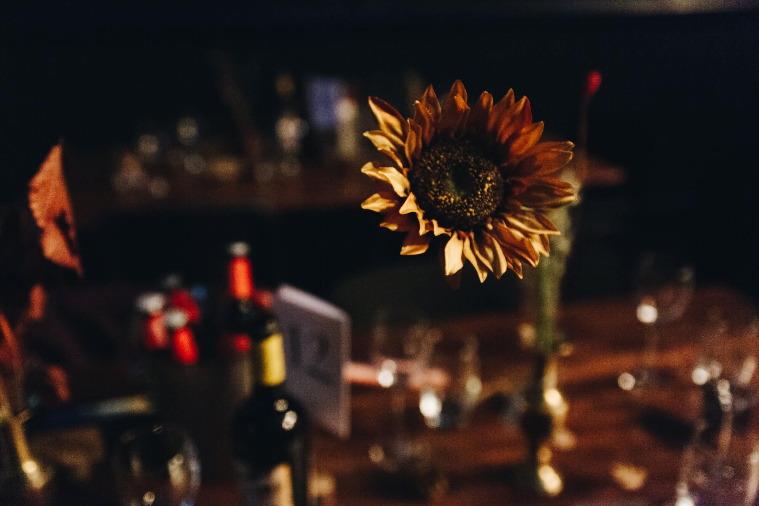 autumn wedding photography sunflower on wedding guest table band on the wall manchester