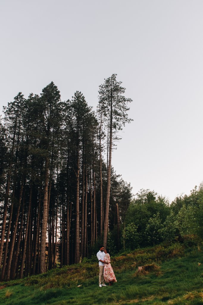 Engaged couple standing close in peak district during a relaxed engagement shoot twilight