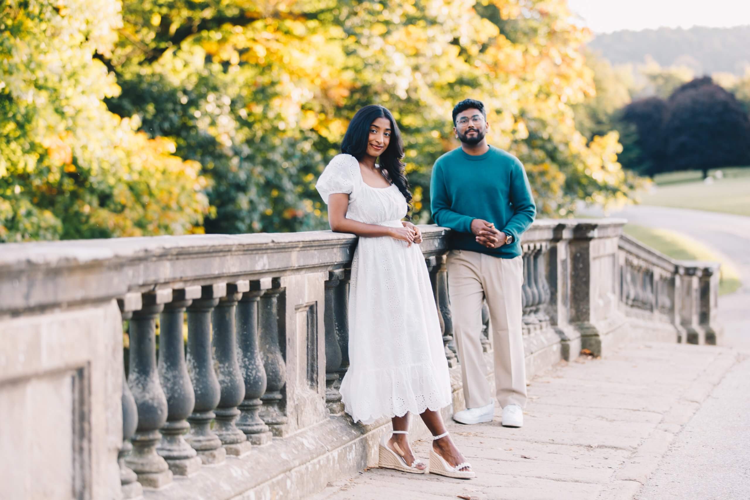 Newly engaged couple walking through Chatsworth gardens