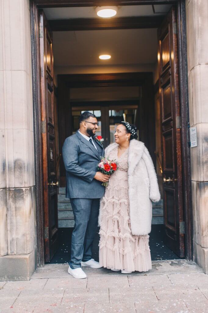 Newlywed couple portrait outside Sale Town Hall