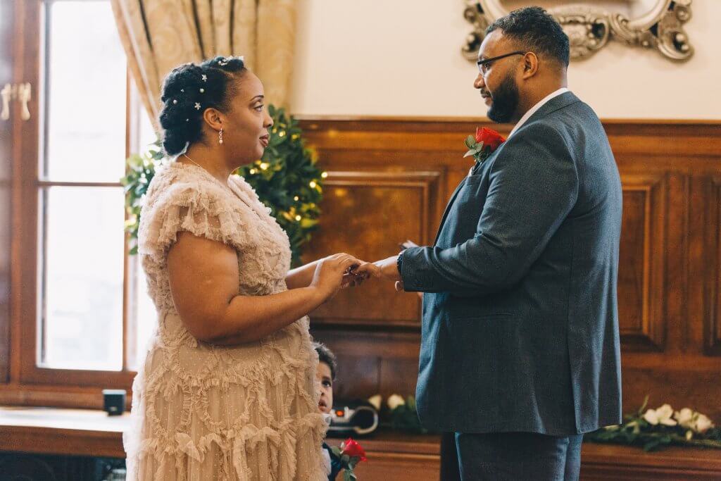 Couple exchanging rings during wedding ceremony