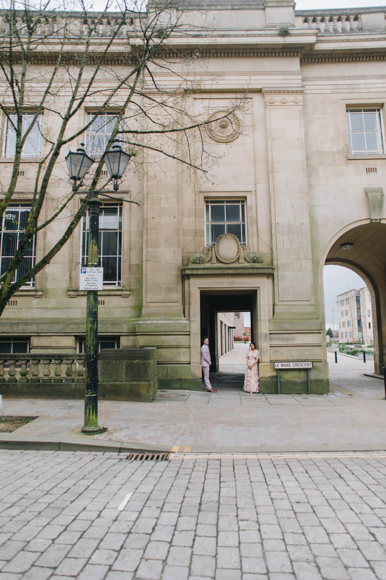 Bride and groom walking by Bolton Town Hall steps wedding photography Bolton