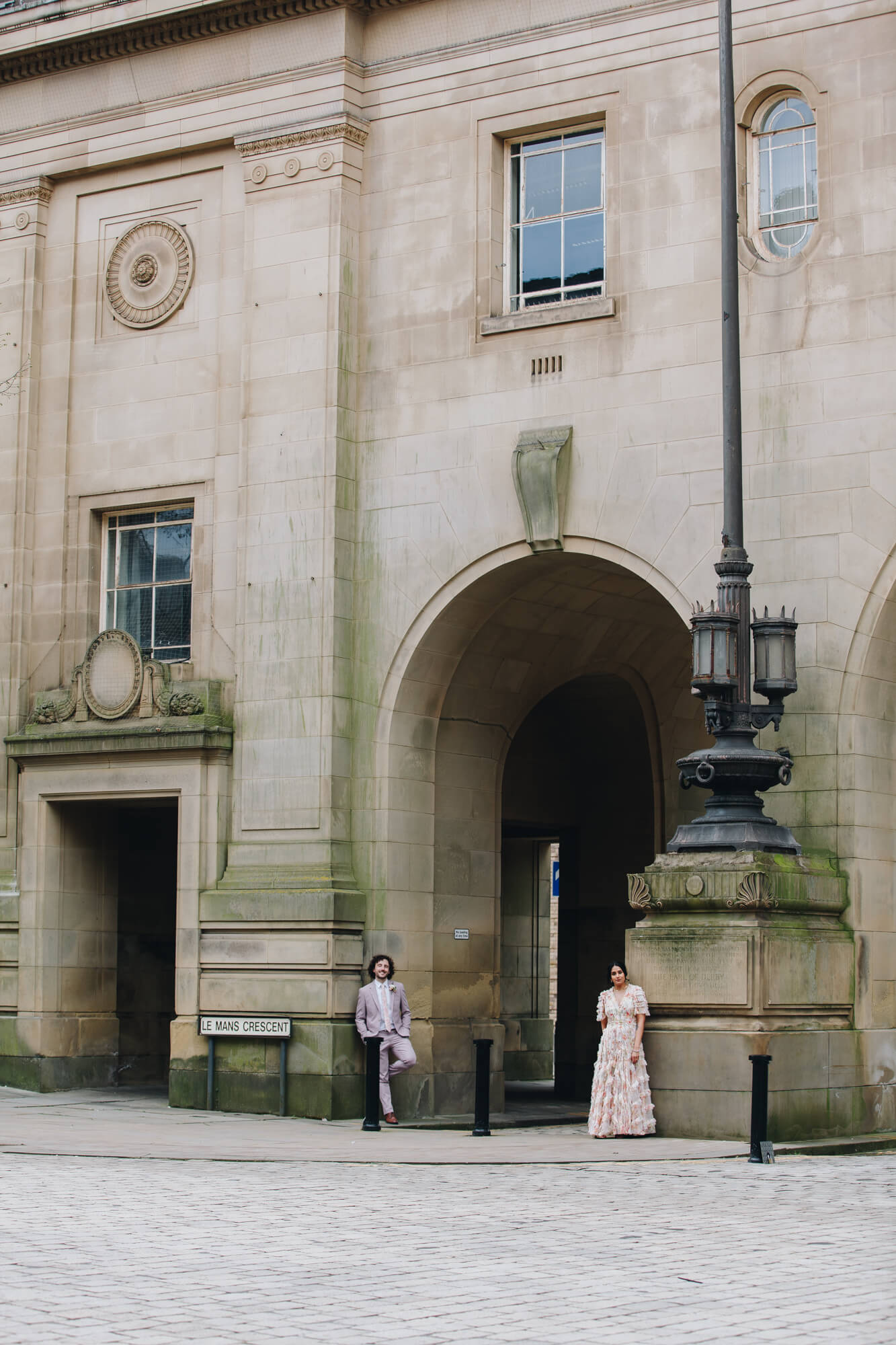 Newlyweds posing at Bolton Town Hall architecture wedding portraits