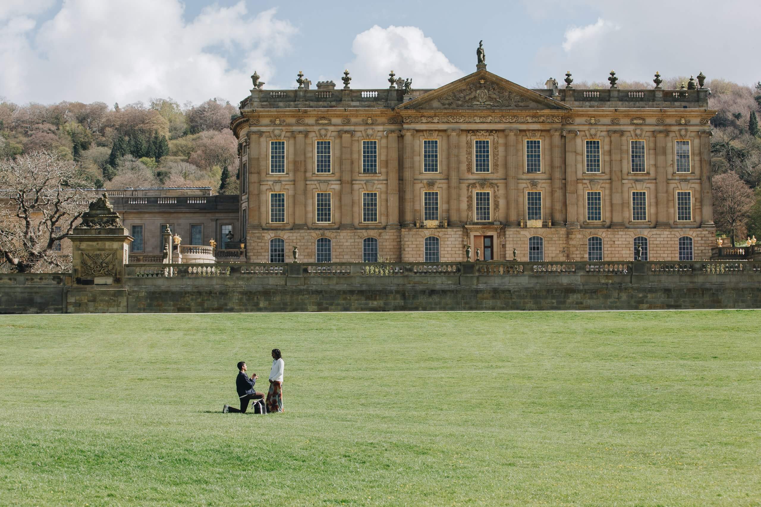 Bride-to-be reacting with joy after surprise proposal at Chatsworth House