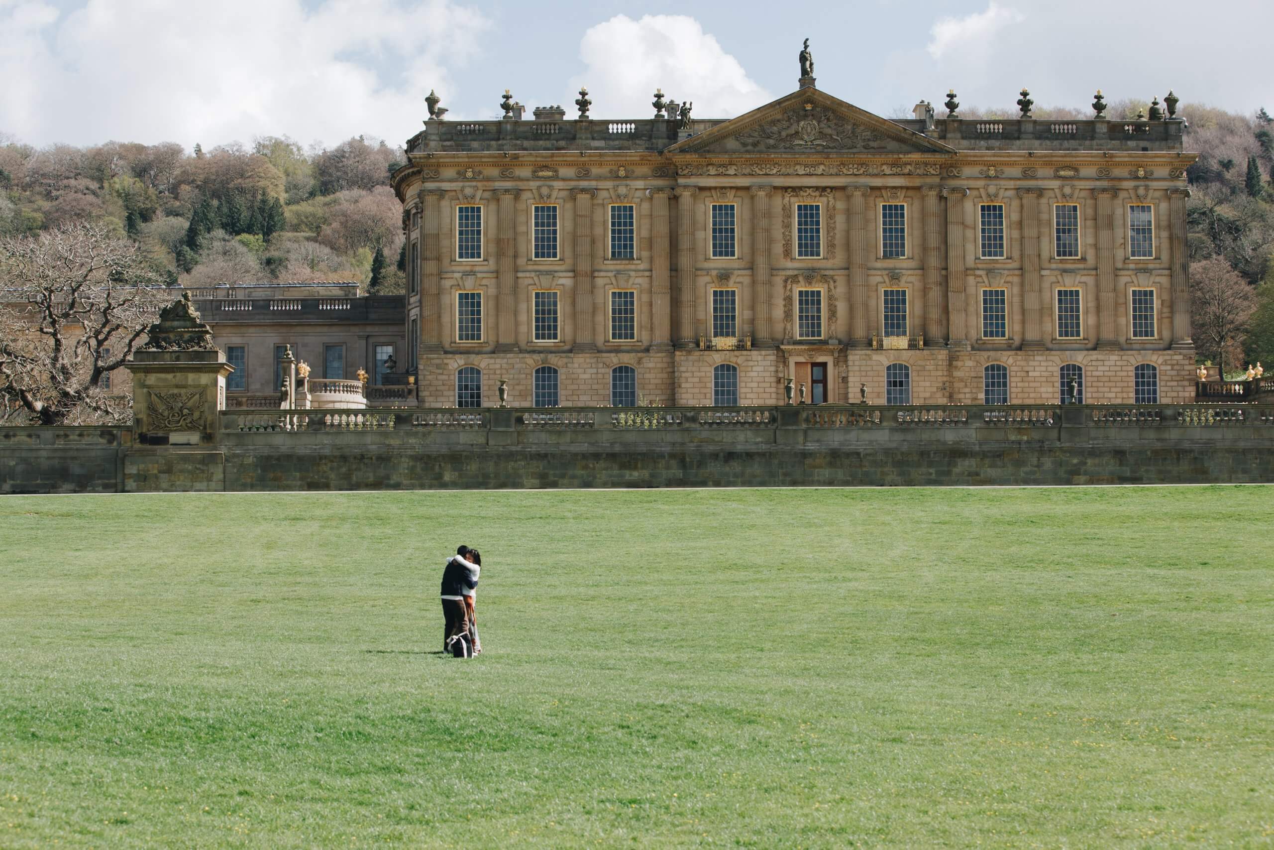 Couple embracing after engagement at Chatsworth House estate