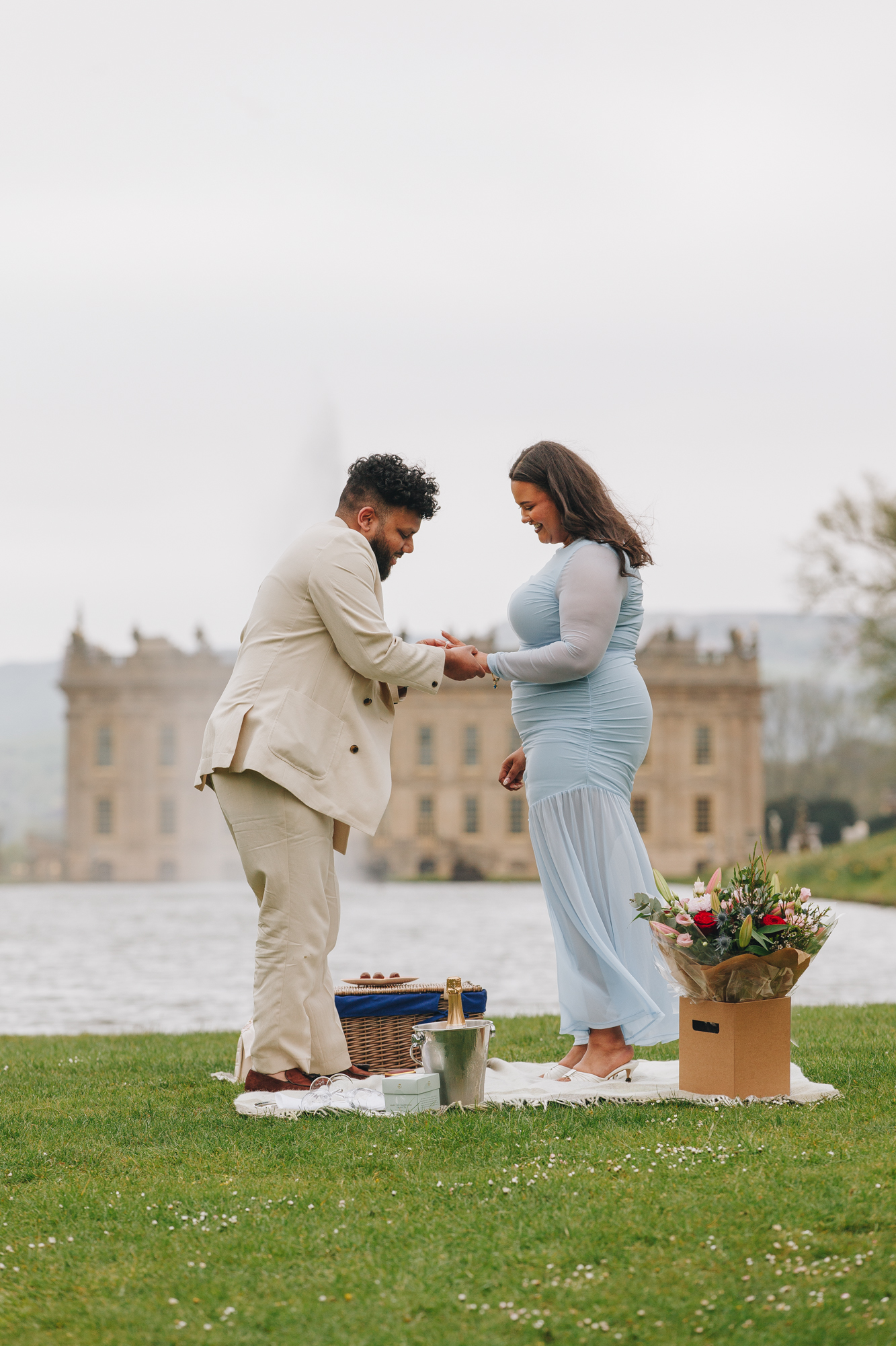 Couple laughing together after proposal at Chatsworth House in spring