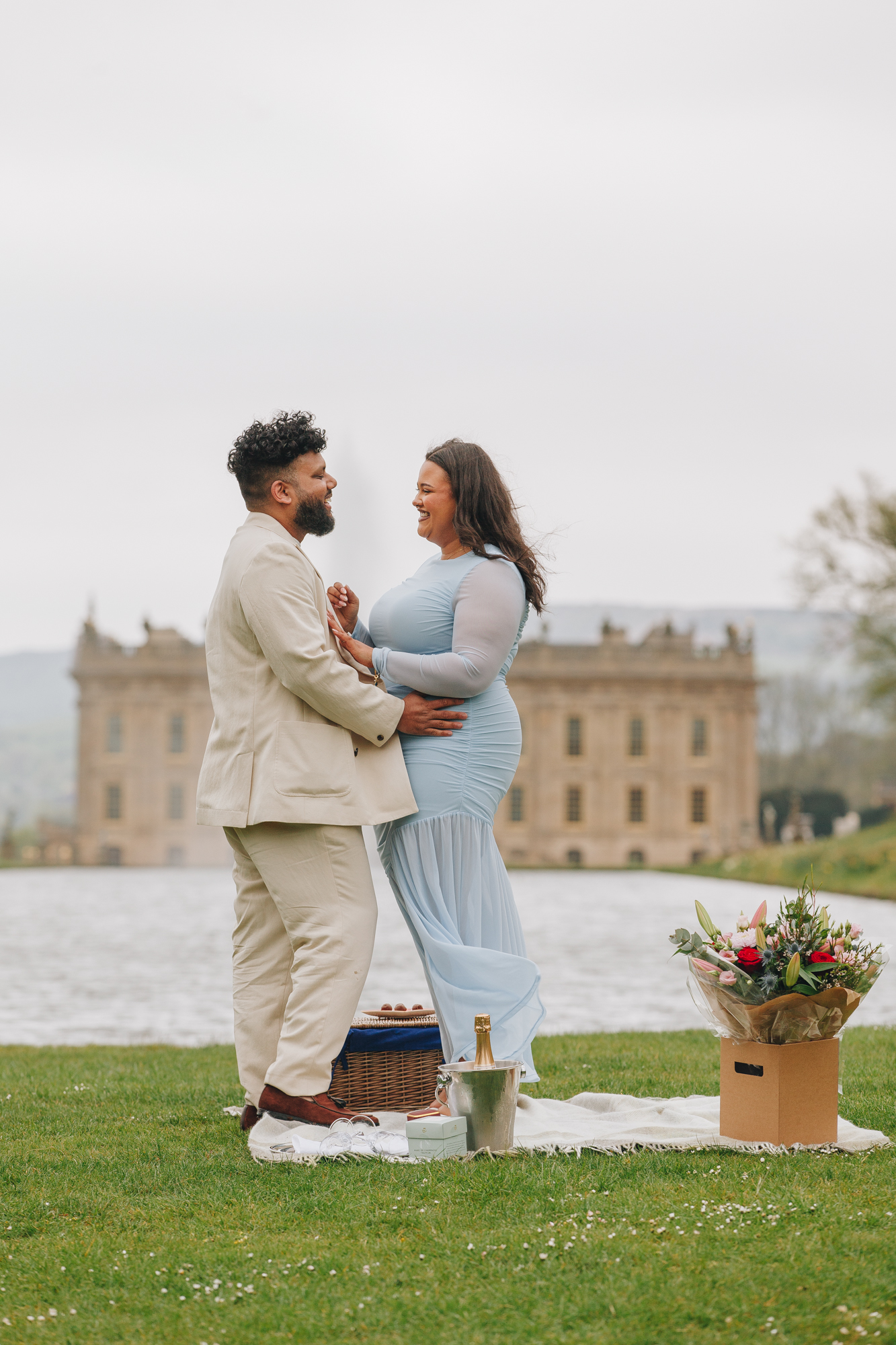 Joyful newly engaged couple celebrating at Chatsworth House