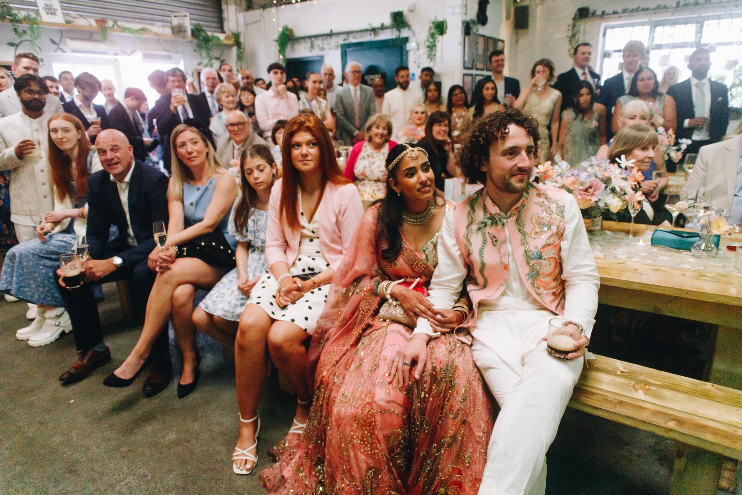 Guests laughing during wedding reception speeches