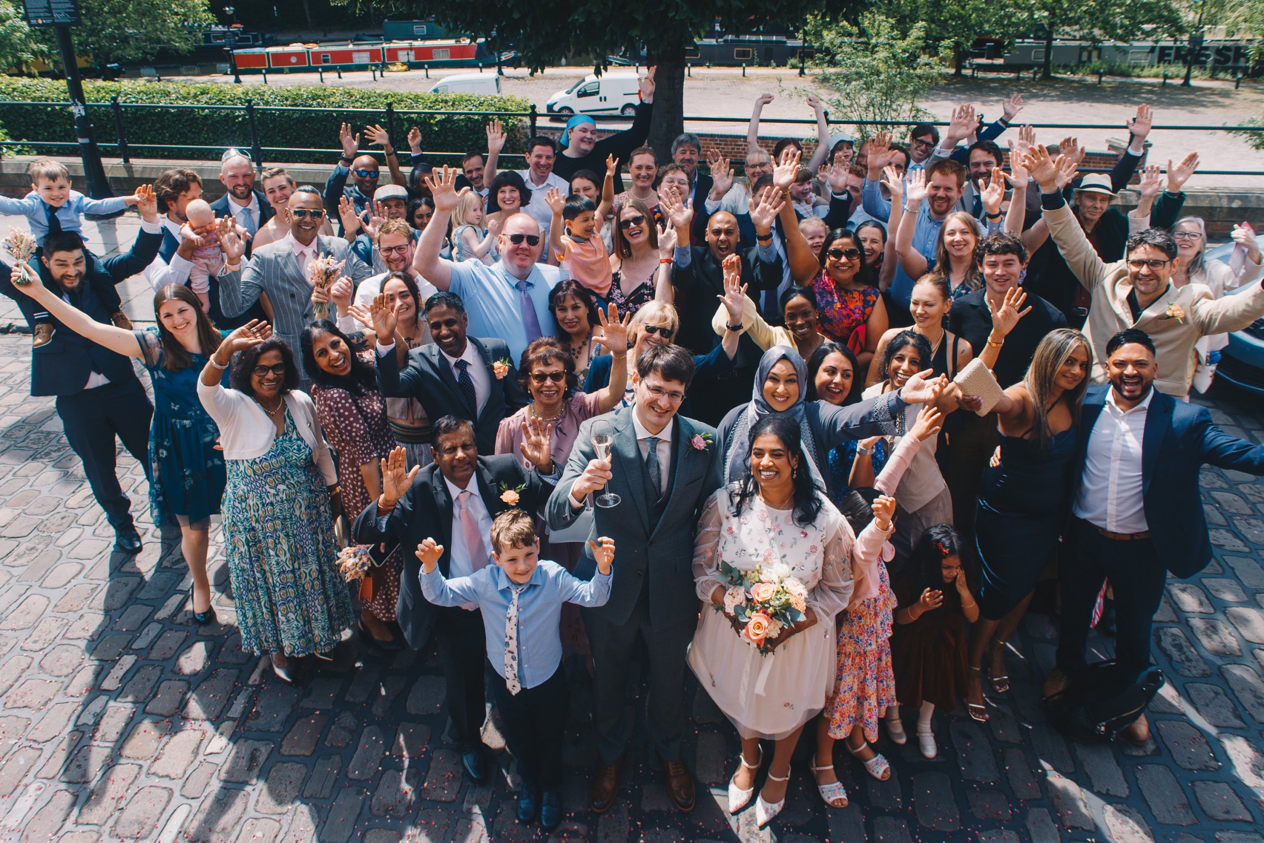 Wedding guests gathered outside The Castlefield Rooms Manchester