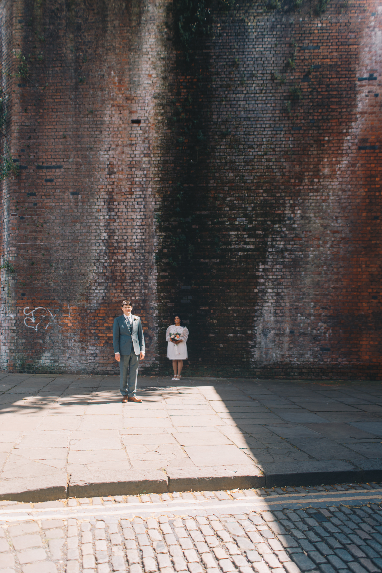 Newlyweds walking along the canal in Castlefield Manchester