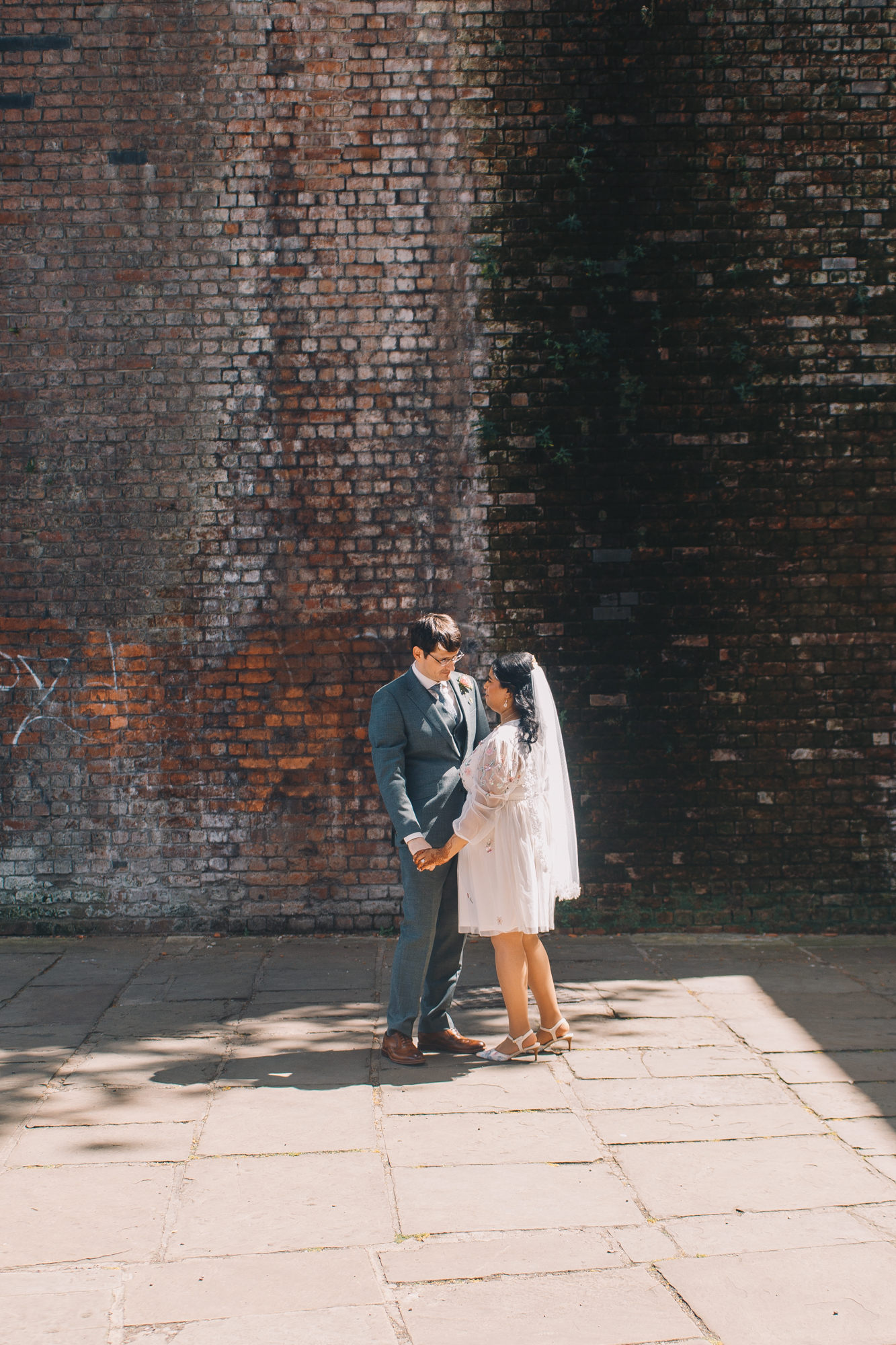 Newlyweds walking along the canal in Castlefield Manchester