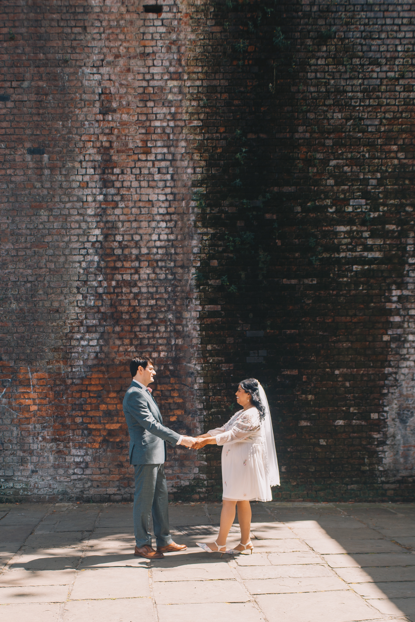 Newlyweds walking along the canal in Castlefield Manchester