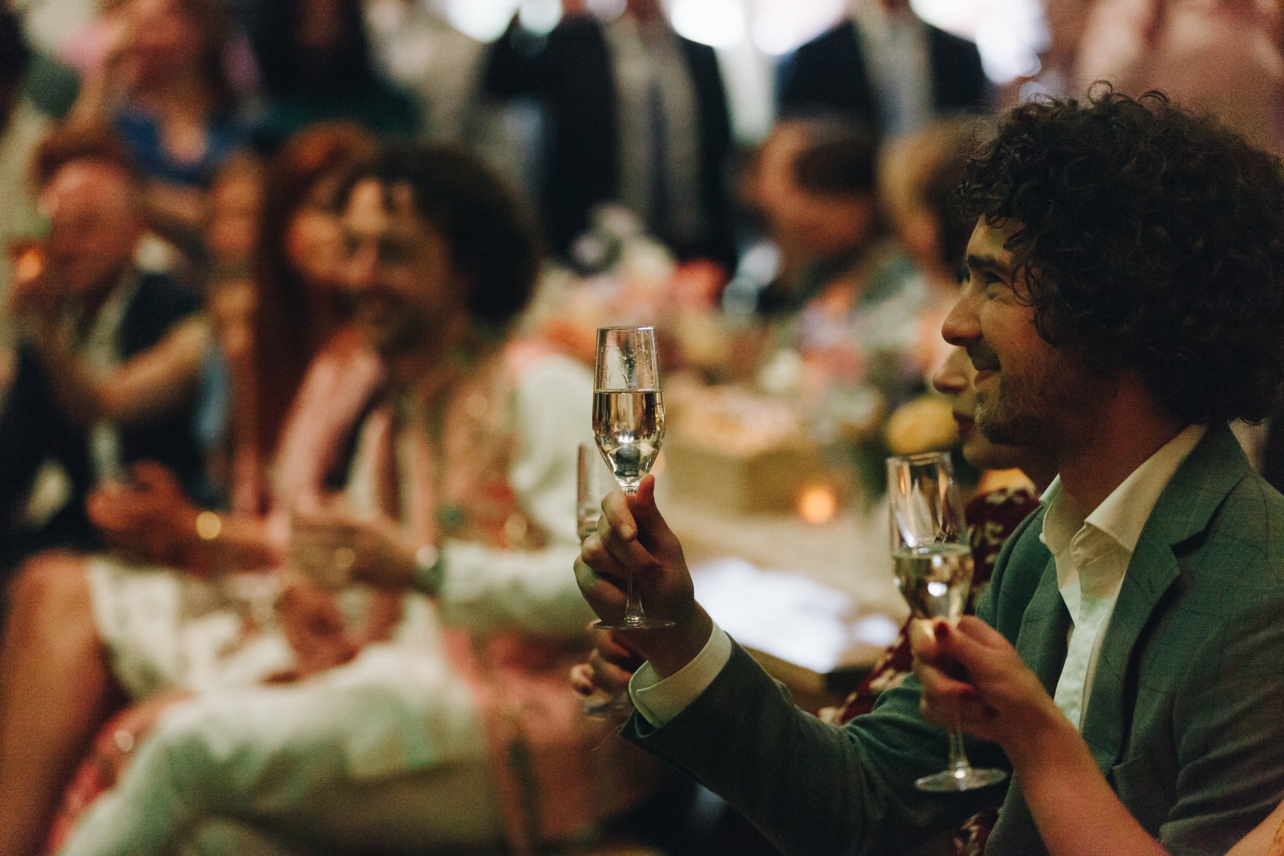 Wedding guests celebrating during evening reception