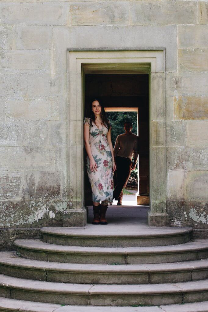 Cinematic engagement portrait of Daniella and Lucas beside the Chatsworth House Cascade
