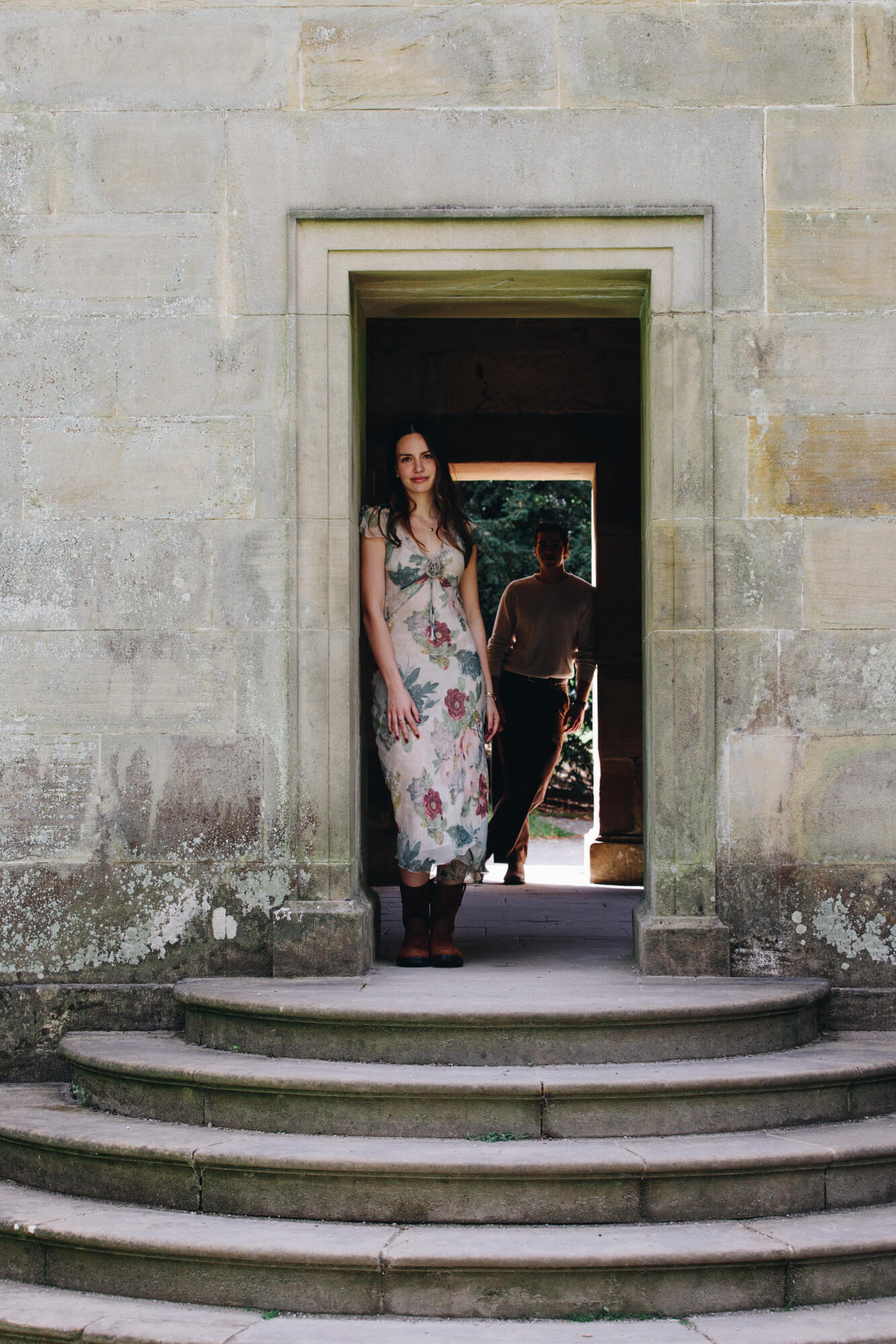 Cinematic engagement portrait of Daniella and Lucas beside the Chatsworth House Cascade