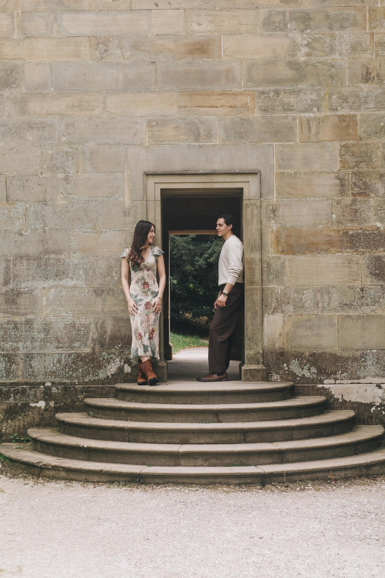 Cinematic engagement portrait of Daniella and Lucas beside the Chatsworth House Cascade